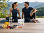 Couple relaxing outdoors with KOYAH Fruit-C capsules pouch and fresh fruit